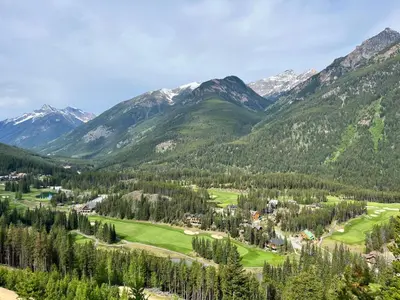 a view of a golf course in the mountains at Perfect Ski or Bike in-out Hot Tub Pool in Panorama