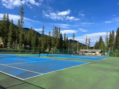a tennis court with two tennis courts at Perfect Ski or Bike in-out Hot Tub Pool in Panorama