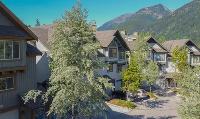 a row of houses with mountains in the background at Hearthstone Townhomes by StayIn in Panorama