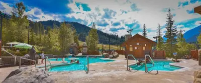 a pool in a resort with people playing in it at Hearthstone Townhomes by StayIn in Panorama