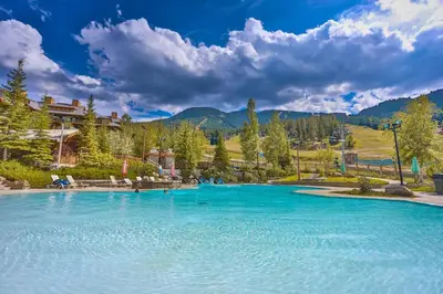 a large pool of blue water in a resort at Hearthstone Townhomes by StayIn in Panorama