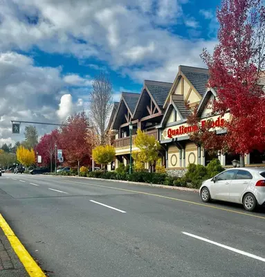 a car parked on the side of a road next to a building at Oceanside Manor - Ocean View in Qualicum Beach