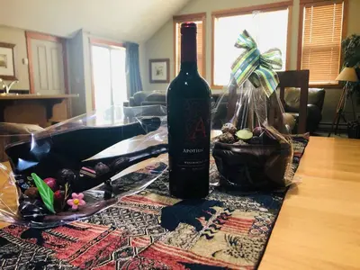 a bottle of wine sitting on top of a table at Wanna get away next Summer and Fall at the Crossing in Canmore
