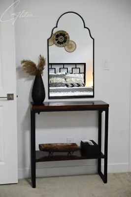 a console table with a mirror and a vase on it at King Bed,Disney,Long Stays,Garage,Airport in Edmonton