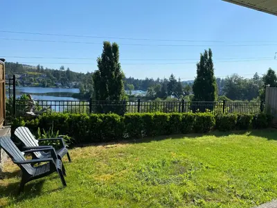 a couple of benches sitting in a yard at Cozy Lakeview Suite in Victoria