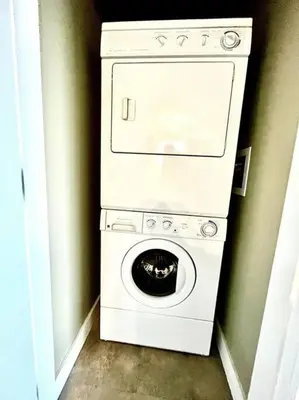 a washer and dryer in a corner of a room at Cozy Lakeview Suite in Victoria