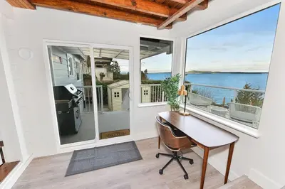 a home office with a desk and a view of the ocean at The Beach House Suite by EMR Vacation Rentals in Chemainus