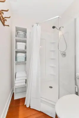 a bathroom with a shower with a shower curtain at The Beach House Suite by EMR Vacation Rentals in Chemainus