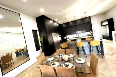 a dining room and kitchen with a table and chairs at Stunning 3BR Luxury Home N/Edm*2 king beds* in Edmonton