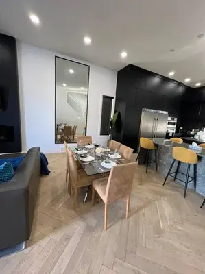 a living room with a table and chairs and a couch at Stunning 3BR Luxury Home N/Edm*2 king beds* in Edmonton
