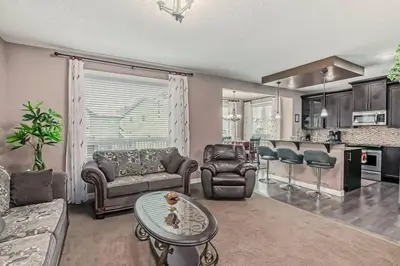 a living room with a couch and a table at Luxury 4 Bedroom Cozy Home close to YYC, Shops, DT, Stampede, Mountains and many amenities in Panorama Hills NW Calgary in Calgary