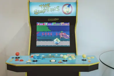 a game room with a video game display on a wall at NYC Loft Inspired •12 mins to WEM •Vintage arcade in Edmonton