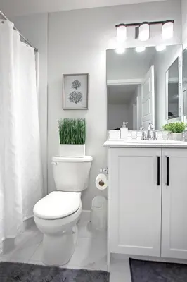 a white bathroom with a toilet and a sink at Beautiful 3Bed-with AC-Close to Spruce Meadows & Mountains in Calgary