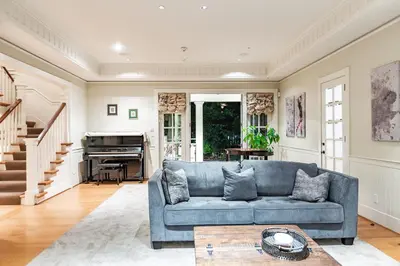 a living room with a blue couch and a piano at Vancouver Golf Villa - Private Oasis in Vancouver