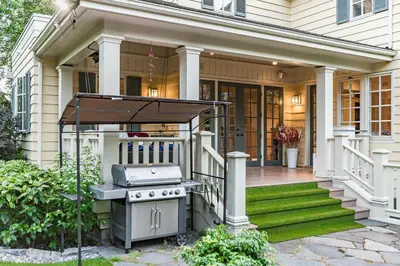 a barbecue on the front porch of a house at Vancouver Golf Villa - Private Oasis in Vancouver