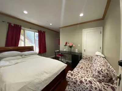 a bedroom with a bed and a window at Cozy Dunbar 3 Beds Home w/ Views in Vancouver