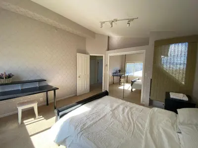 a bedroom with a bed and a desk in it at Cozy Dunbar 3 Beds Home w/ Views in Vancouver