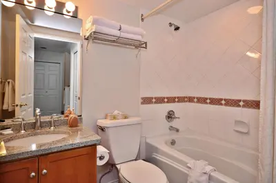 a bathroom with a tub and a toilet and a sink at Villas at Eldorado Resort in Kelowna