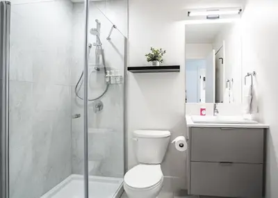 a bathroom with a shower and a toilet and a sink at Switchback Suite by Revelstoke Vacations in Revelstoke