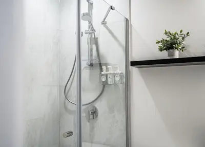 a bathroom with a shower with a glass door at Switchback Suite by Revelstoke Vacations in Revelstoke