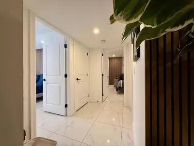 a hallway with a white door and a room at Brand New 2 Bedroom Suite in Langley Twp - Play Area, Patio & Mini Golf in Aldergrove