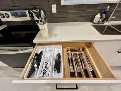 a kitchen counter with a drawer filled with utensils at Brand New 2 Bedroom Suite in Langley Twp - Play Area, Patio & Mini Golf in Aldergrove
