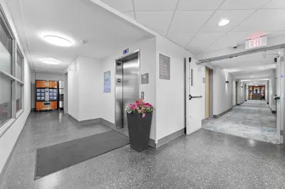 a hallway of an office building with a vase of flowers at Home Inn and Suites Lloydminster in Lloydminster