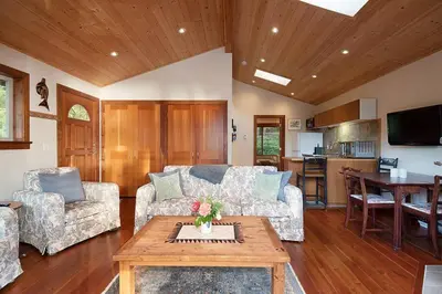 a living room with a couch and a table at Caboose in Bowen Island