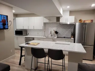 a kitchen with a white counter top and a refrigerator at Lakeview B&B in Peachland