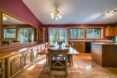 a kitchen with a wooden table and some windows at Fairmont Hot Springs, 3 Bedroom Vacation Home in Fairmont Hot Springs