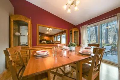 a dining room with a wooden table and chairs at Fairmont Hot Springs, 3 Bedroom Vacation Home in Fairmont Hot Springs