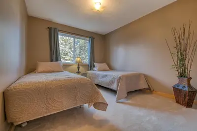 a bedroom with two beds and a window at Fairmont Hot Springs, 3 Bedroom Vacation Home in Fairmont Hot Springs