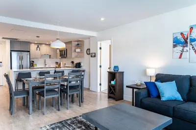 a living room with a couch and a table at Alpine Dream by Revelstoke Vacations in Revelstoke