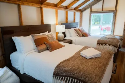 a bedroom with two beds and a window at Sundance By Basecamp in Kananaskis Village
