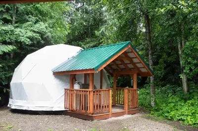 a yurt with a porch and a gazebo at Revelstoke RV & Cabin Resort in Revelstoke