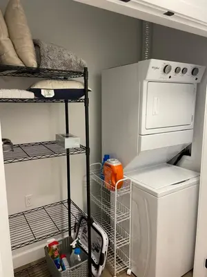 a laundry room with a washing machine and a drying rack at Adorable 1 Bedroom Suite- a skip to Galloping Goose in Victoria
