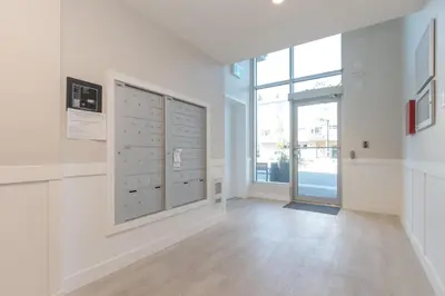 a room with white walls and a large window at Live The Dream In The Haro in Saanichton