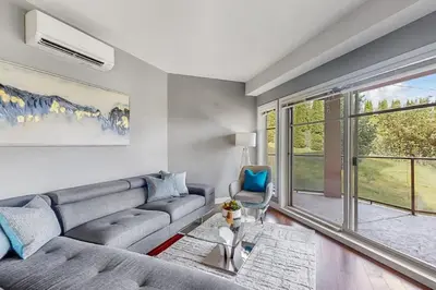 a living room with a couch and a window at Luxury Getaway at Copper Sky 104 in West Kelowna