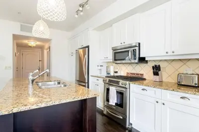 a kitchen with a sink and a stove top oven at The Beach House at Barona Beach 4301 in West Kelowna