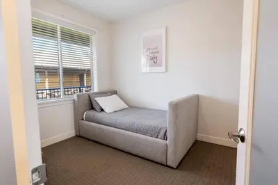 a bed in a room with a window at The Beach House at Barona Beach 4301 in West Kelowna