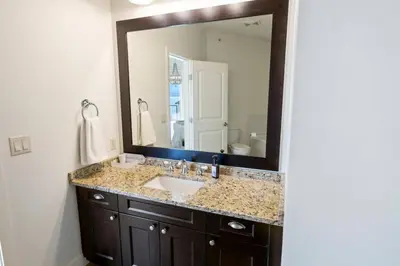 a bathroom with a sink and a large mirror at The Beach House at Barona Beach 4301 in West Kelowna