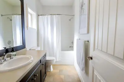 a white bathroom with a sink and a toilet at The Beach House at Barona Beach 4301 in West Kelowna