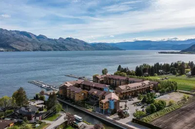 an aerial view of a resort next to a body of water at The Beach House at Barona Beach 4301 in West Kelowna