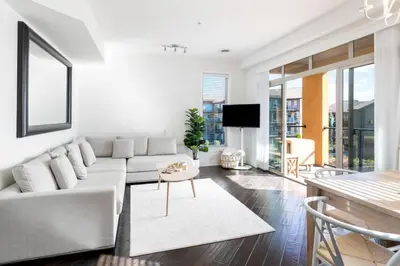 a living room with a white couch and a table at The Beach House at Barona Beach 4301 in West Kelowna