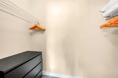 a closet with a black dresser and hangers at Top Floor Apartment at Amenity Rich Resort 406 in West Kelowna