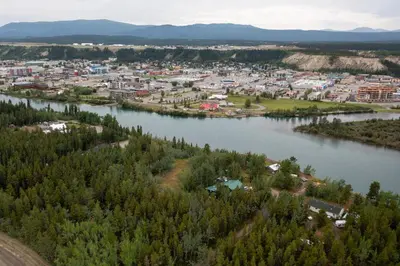 an aerial view of a town next to a river at Yukon River Farm in Whitehorse