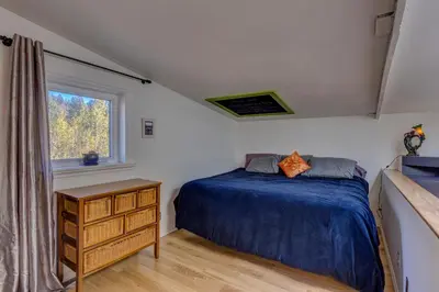 a bedroom with a bed and a window at Yukon River Farm in Whitehorse