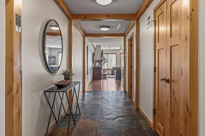 a hallway of a home with a mirror and a table at 3 Bedroom Condo by Canadian Rockies Vacation Rentals in Canmore