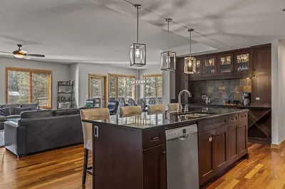 an open kitchen and living room with a couch at 3 Bedroom Condo by Canadian Rockies Vacation Rentals in Canmore