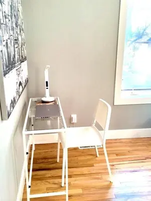 a white desk with a laptop and a white chair at Cozy 3 Bedroom Contemporary Home With Free Parking in Edmonton